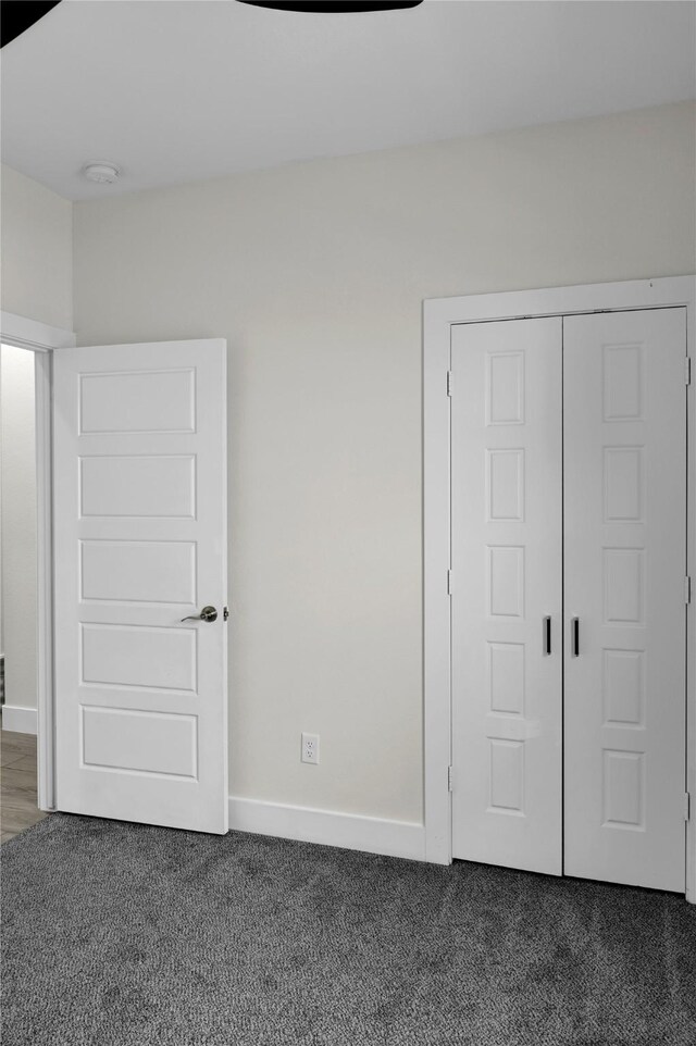 5506 Cold Water Trl, Granbury, TX 76048 - unfurnished bedroom featuring dark colored carpet, baseboards, and a closet