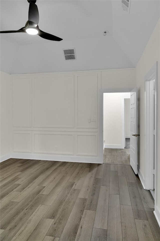 5506 Cold Water Trl, Granbury, TX 76048 - unfurnished room with lofted ceiling, a decorative wall, wood finished floors, and a ceiling fan
