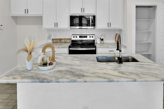 5506 Cold Water Trl, Granbury, TX 76048 - kitchen with appliances with stainless steel finishes, a sink, light stone counters, backsplash, and white cabinets