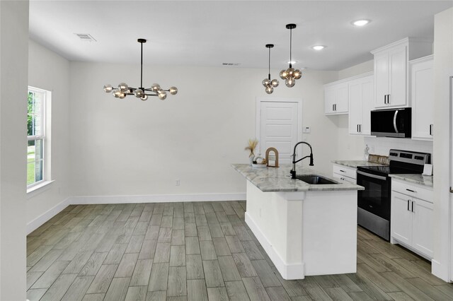 5506 Cold Water Trl, Granbury, TX 76048 - kitchen featuring stainless steel range with electric cooktop, a sink, a chandelier, wood finished floors, and light stone countertops