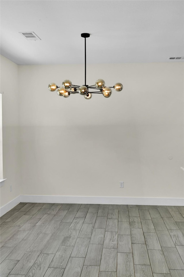 5506 Cold Water Trl, Granbury, TX 76048 - empty room featuring a chandelier, wood finished floors, and baseboards