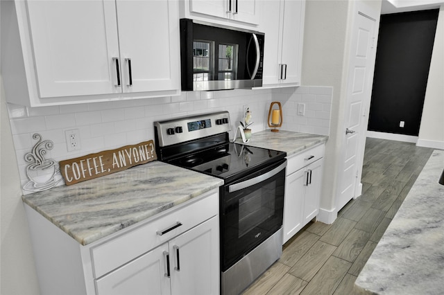 5506 Cold Water Trl, Granbury, TX 76048 - kitchen featuring appliances with stainless steel finishes, white cabinetry, wood tiled floors, and baseboards