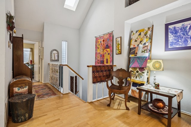 9222 Church Rd Unit 108, Dallas, TX 75231 - entrance foyer featuring a skylight, wood finished floors, and high vaulted ceiling