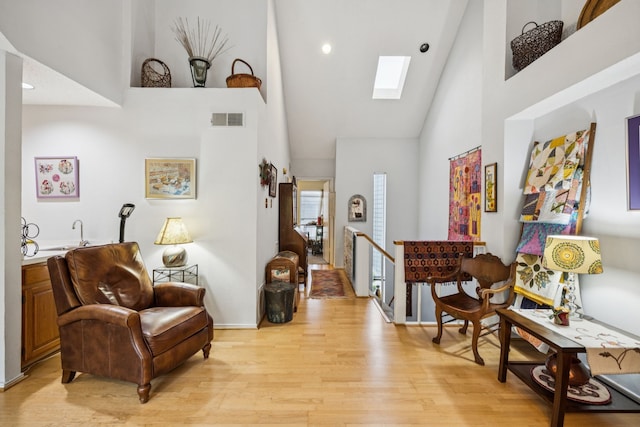 9222 Church Rd Unit 108, Dallas, TX 75231 - living area featuring high vaulted ceiling, a skylight, light wood finished floors, an upstairs landing, and recessed lighting