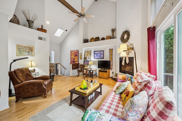 9222 Church Rd Unit 108, Dallas, TX 75231 - living room with high vaulted ceiling, light wood-style floors, a skylight, a ceiling fan, and recessed lighting