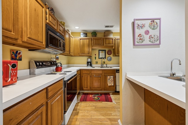 9222 Church Rd Unit 108, Dallas, TX 75231 - kitchen with electric stove, black microwave, a sink, light wood-style floors, and recessed lighting