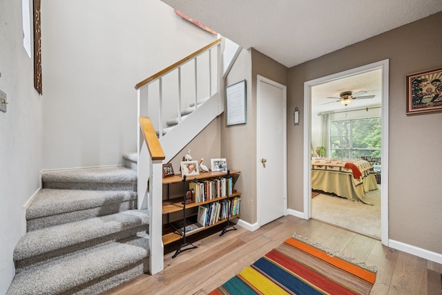 9222 Church Rd Unit 108, Dallas, TX 75231 - stairway featuring wood finished floors, baseboards, and ceiling fan