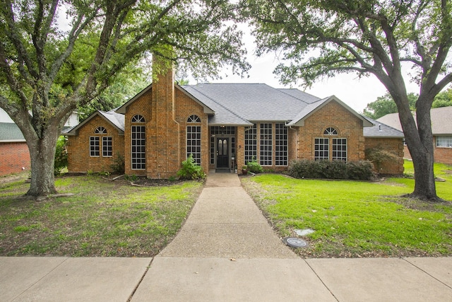 611 Christan Ct, Rockwall, TX 75087 - view of front facade featuring a chimney, a front lawn, and brick siding