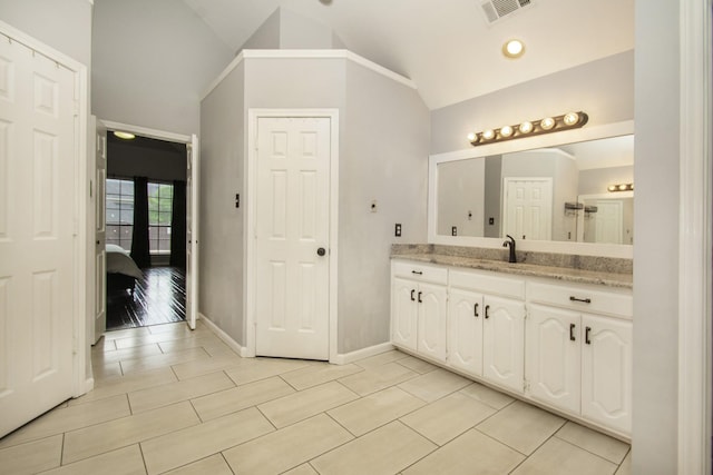 611 Christan Ct, Rockwall, TX 75087 - bathroom with vanity, tile patterned flooring, baseboards, and high vaulted ceiling
