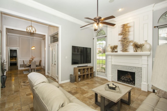 611 Christan Ct, Rockwall, TX 75087 - living room featuring stone tile flooring, a chandelier, ceiling fan, ornamental molding, and a fireplace