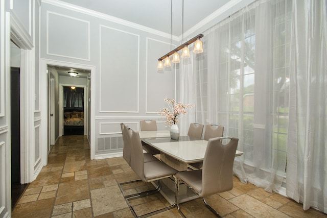 611 Christan Ct, Rockwall, TX 75087 - dining room featuring stone tile flooring, a decorative wall, and crown molding