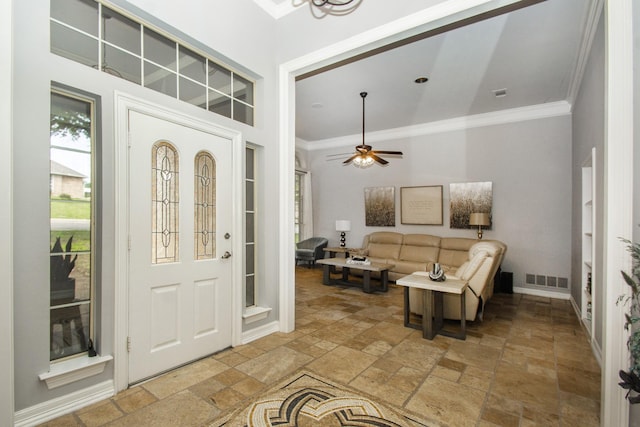 611 Christan Ct, Rockwall, TX 75087 - entryway with stone tile flooring, crown molding, ceiling fan, and baseboards