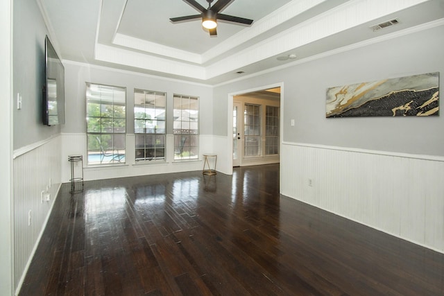 611 Christan Ct, Rockwall, TX 75087 - empty room with ceiling fan, a raised ceiling, hardwood / wood-style floors, wainscoting, and ornamental molding