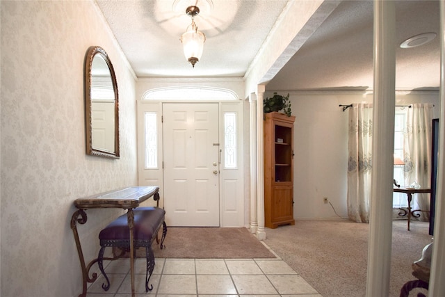 738 Westwood Dr, Marlin, TX 76661 - foyer featuring light carpet, a textured ceiling, crown molding, and light tile patterned floors
