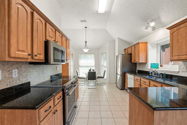2229 Brooklake St W, Denton, TX 76207 - kitchen with stainless steel appliances, lofted ceiling, backsplash, a sink, and dark stone countertops