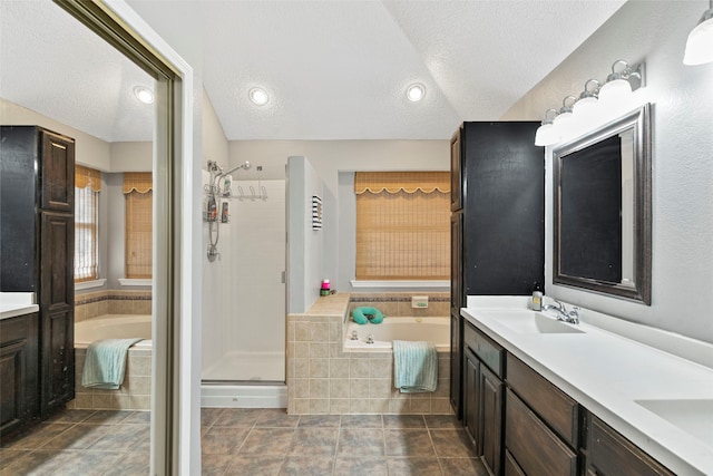 2229 Brooklake St W, Denton, TX 76207 - bathroom with double vanity, a bath, a shower stall, and a textured ceiling