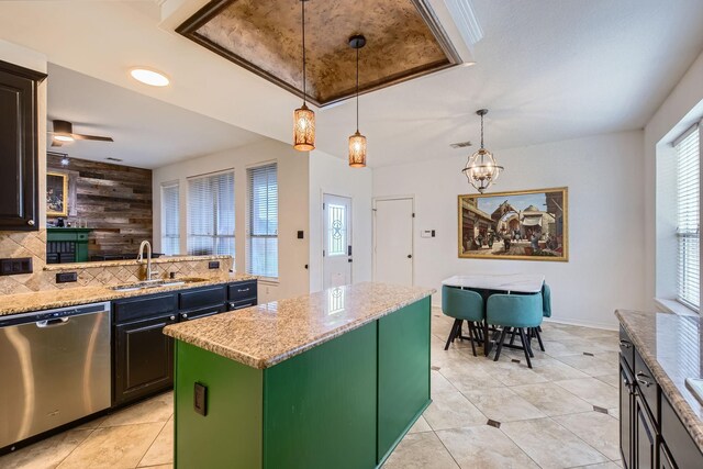 3905 Lakeside Dr, Rowlett, TX 75088 - kitchen with dishwasher, a sink, decorative backsplash, light tile patterned floors, and a center island