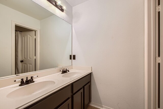 3905 Lakeside Dr, Rowlett, TX 75088 - bathroom with double vanity and baseboards