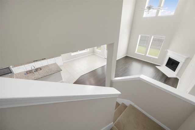 4104 Portola Dr, Mckinney, TX 75070 - stairs with healthy amount of natural light, a fireplace with raised hearth, and ceiling fan