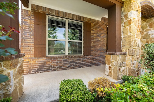 4104 Portola Dr, Mckinney, TX 75070 - doorway to property featuring brick siding, a porch, and stone siding