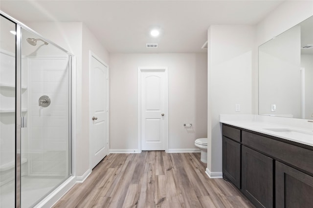 6310 Racer Summit Dr, Dallas, TX 75241 - bathroom with wood finished floors, vanity, a shower stall, toilet, and baseboards