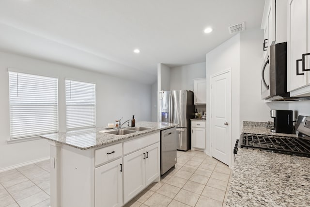 140 Running River Dr, Boyd, TX 76023 - kitchen featuring stainless steel appliances, light tile patterned floors, an island with sink, white cabinetry, and recessed lighting