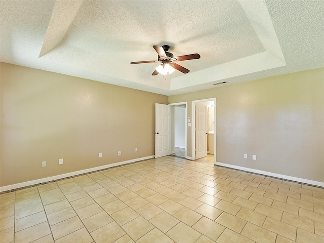 7275 Fm 455 W, Sanger, TX 76266 - unfurnished room with ceiling fan, a textured ceiling, a tray ceiling, and baseboards