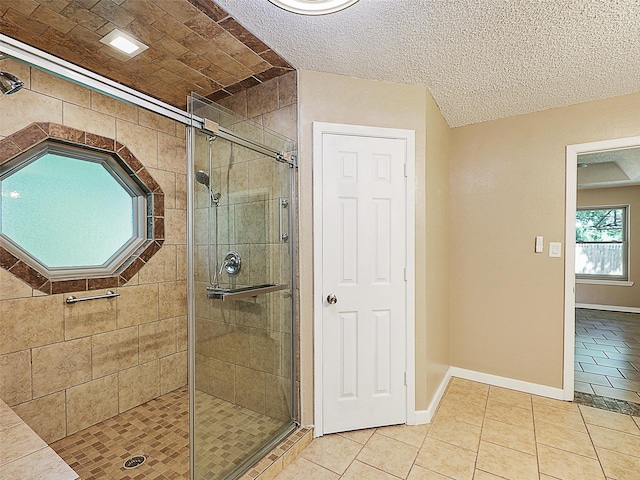 7275 Fm 455 W, Sanger, TX 76266 - full bathroom featuring tile patterned flooring, a stall shower, baseboards, and a textured ceiling