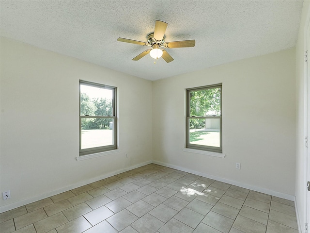 7275 Fm 455 W, Sanger, TX 76266 - empty room with a ceiling fan, a textured ceiling, light tile patterned floors, and baseboards
