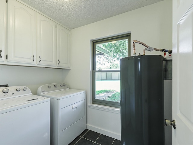 7275 Fm 455 W, Sanger, TX 76266 - laundry area featuring cabinet space, independent washer and dryer, water heater, dark tile patterned floors, and a textured ceiling