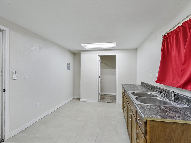 7275 Fm 455 W, Sanger, TX 76266 - kitchen featuring a sink, dark countertops, and baseboards