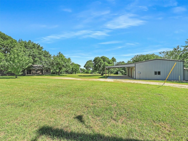 7275 Fm 455 W, Sanger, TX 76266 - view of grassy yard with a pole building, dirt driveway, an outbuilding, and a garage