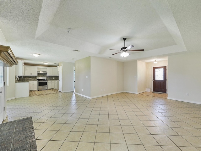7275 Fm 455 W, Sanger, TX 76266 - unfurnished living room featuring a textured ceiling, light tile patterned flooring, a ceiling fan, and baseboards