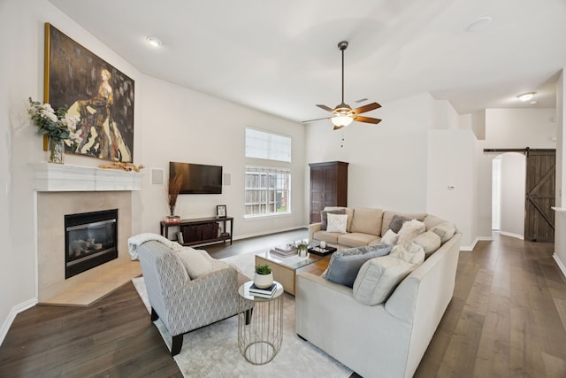 945 Brentwood Dr, Murphy, TX 75094 - living area featuring a barn door, a fireplace, ceiling fan, and wood finished floors