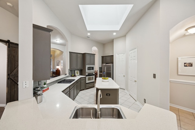 945 Brentwood Dr, Murphy, TX 75094 - kitchen with stainless steel appliances, a sink, light countertops, light tile patterned flooring, and gray cabinetry