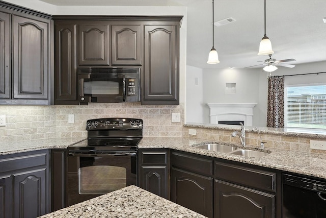 3112 Stonecrop Trl, Denton, TX 76226 - kitchen with black appliances, ceiling fan, backsplash, light stone countertops, and dark brown cabinets