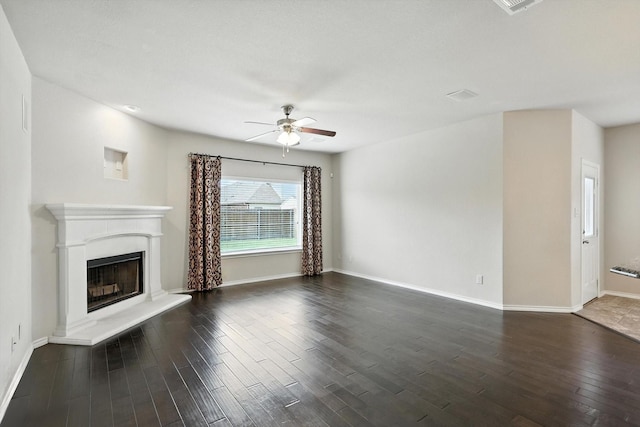 3112 Stonecrop Trl, Denton, TX 76226 - unfurnished living room featuring ceiling fan, dark wood-type flooring, and a fireplace with raised hearth