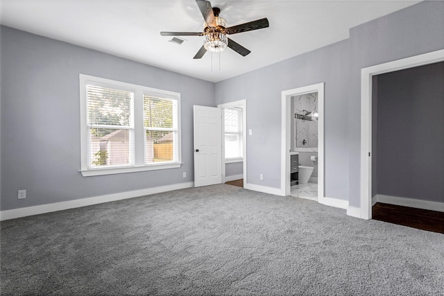 729 S Winnetka Ave, Dallas, TX 75208 - unfurnished bedroom featuring carpet floors, connected bathroom, baseboards, and ceiling fan