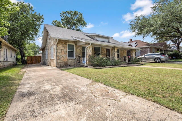 729 S Winnetka Ave, Dallas, TX 75208 - bungalow featuring stone siding, driveway, covered porch, and a shingled roof