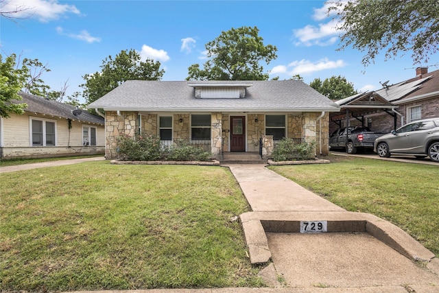 729 S Winnetka Ave, Dallas, TX 75208 - bungalow-style house with stone siding, covered porch, a front yard, and roof with shingles