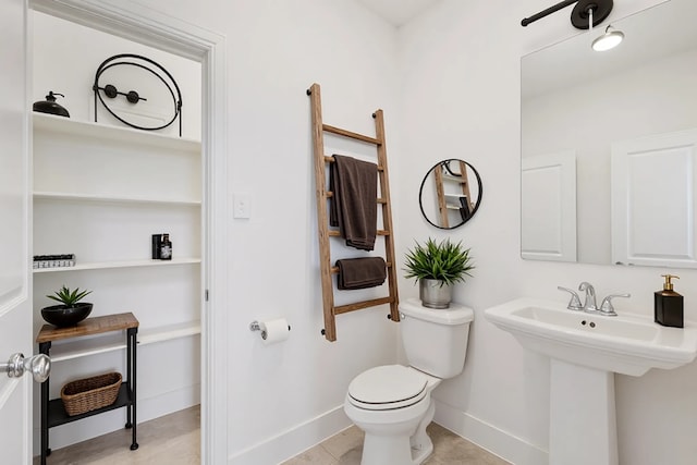 1721 Horseshoe Ln, Van Alstyne, TX 75495 - bathroom with toilet, baseboards, and a sink