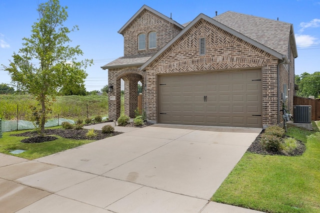 1721 Horseshoe Ln, Van Alstyne, TX 75495 - french country home featuring brick siding, a shingled roof, concrete driveway, and a garage