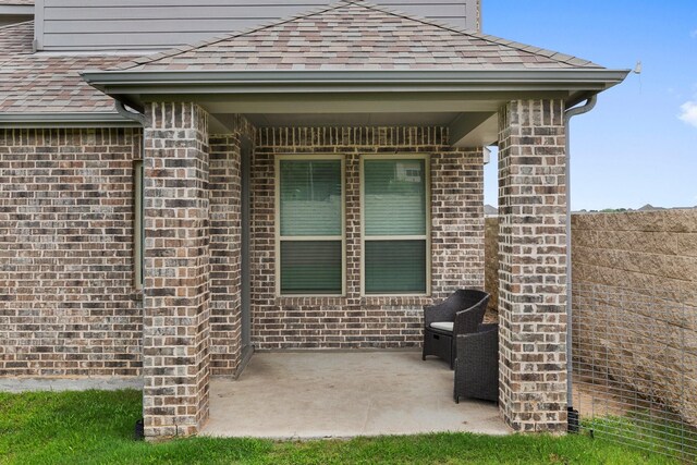 1721 Horseshoe Ln, Van Alstyne, TX 75495 - back of house featuring a patio, roof with shingles, and brick siding