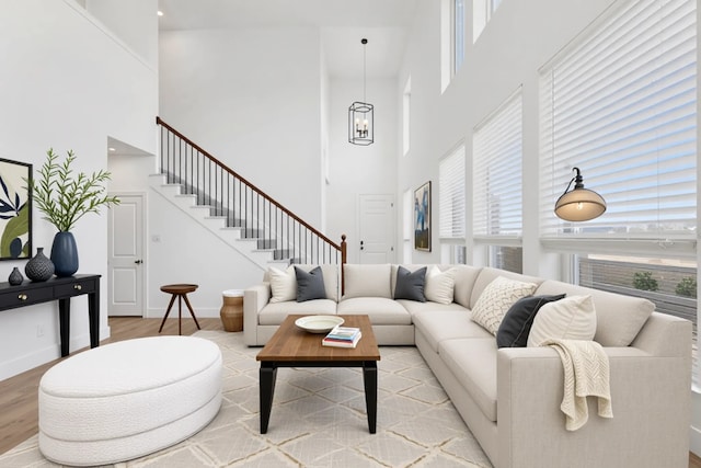 1721 Horseshoe Ln, Van Alstyne, TX 75495 - living area featuring a high ceiling, light wood-type flooring, and stairs