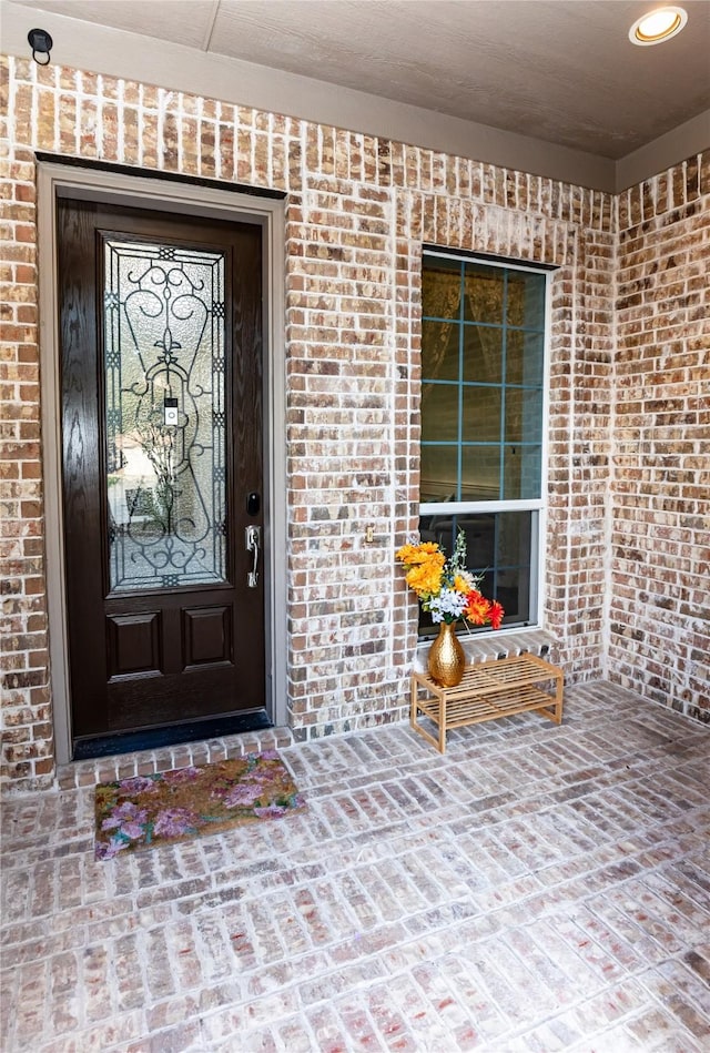 6925 Mercy Rd, Frisco, TX 75035 - view of exterior entry featuring brick siding