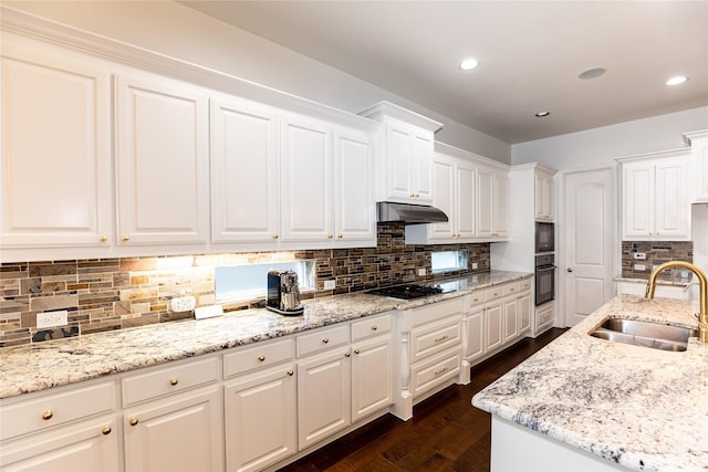 6925 Mercy Rd, Frisco, TX 75035 - kitchen featuring a sink, black appliances, tasteful backsplash, dark wood finished floors, and white cabinetry