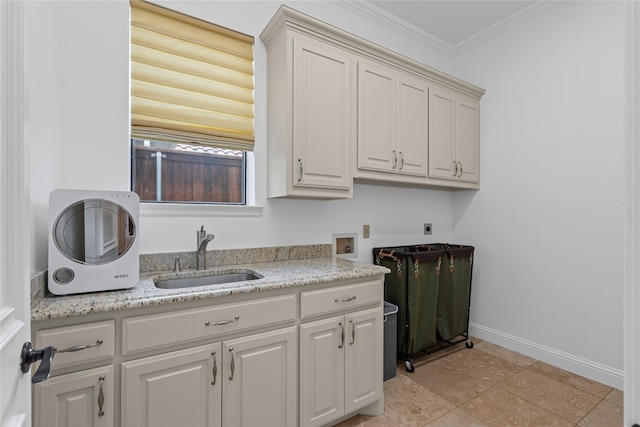 10388 Tobias Ln, Frisco, TX 75033 - laundry area with cabinet space, hookup for an electric dryer, hookup for a washing machine, crown molding, and baseboards