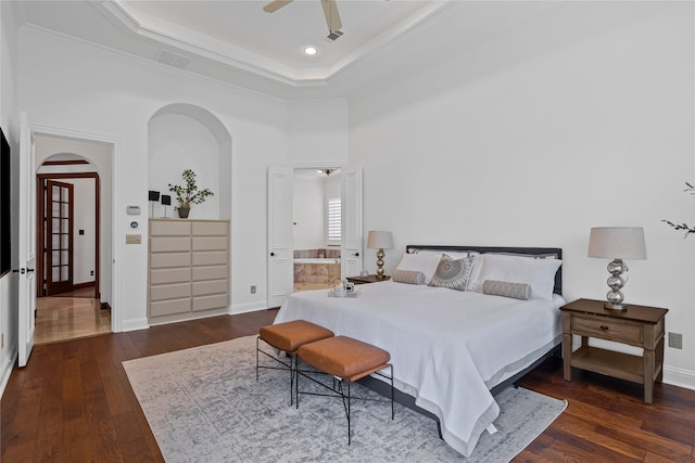 10388 Tobias Ln, Frisco, TX 75033 - bedroom with arched walkways, crown molding, hardwood / wood-style flooring, a tray ceiling, and baseboards