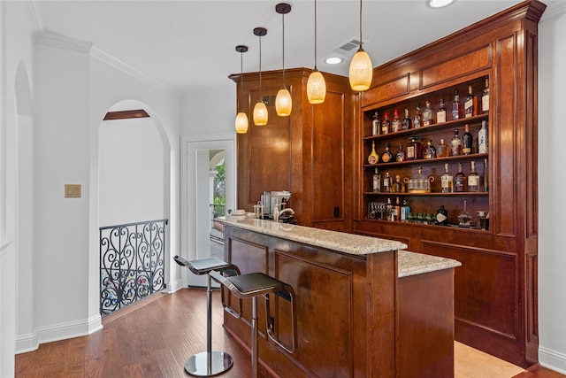 10388 Tobias Ln, Frisco, TX 75033 - bar area with arched walkways, crown molding, pendant lighting, wood finished floors, and baseboards