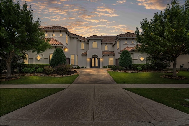 10388 Tobias Ln, Frisco, TX 75033 - mediterranean / spanish-style house with driveway, stucco siding, a tiled roof, and a lawn